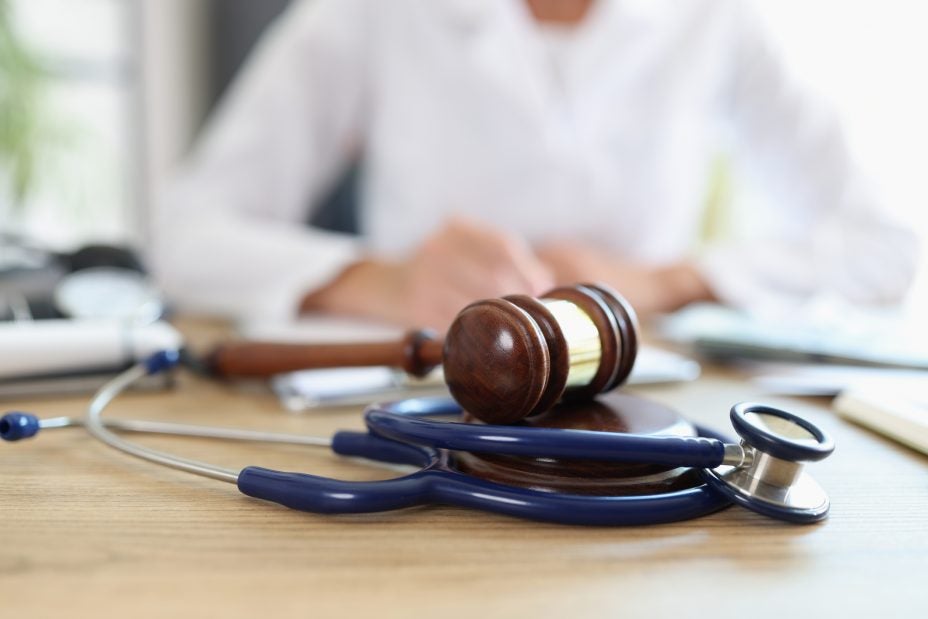person with gavel and stethoscope