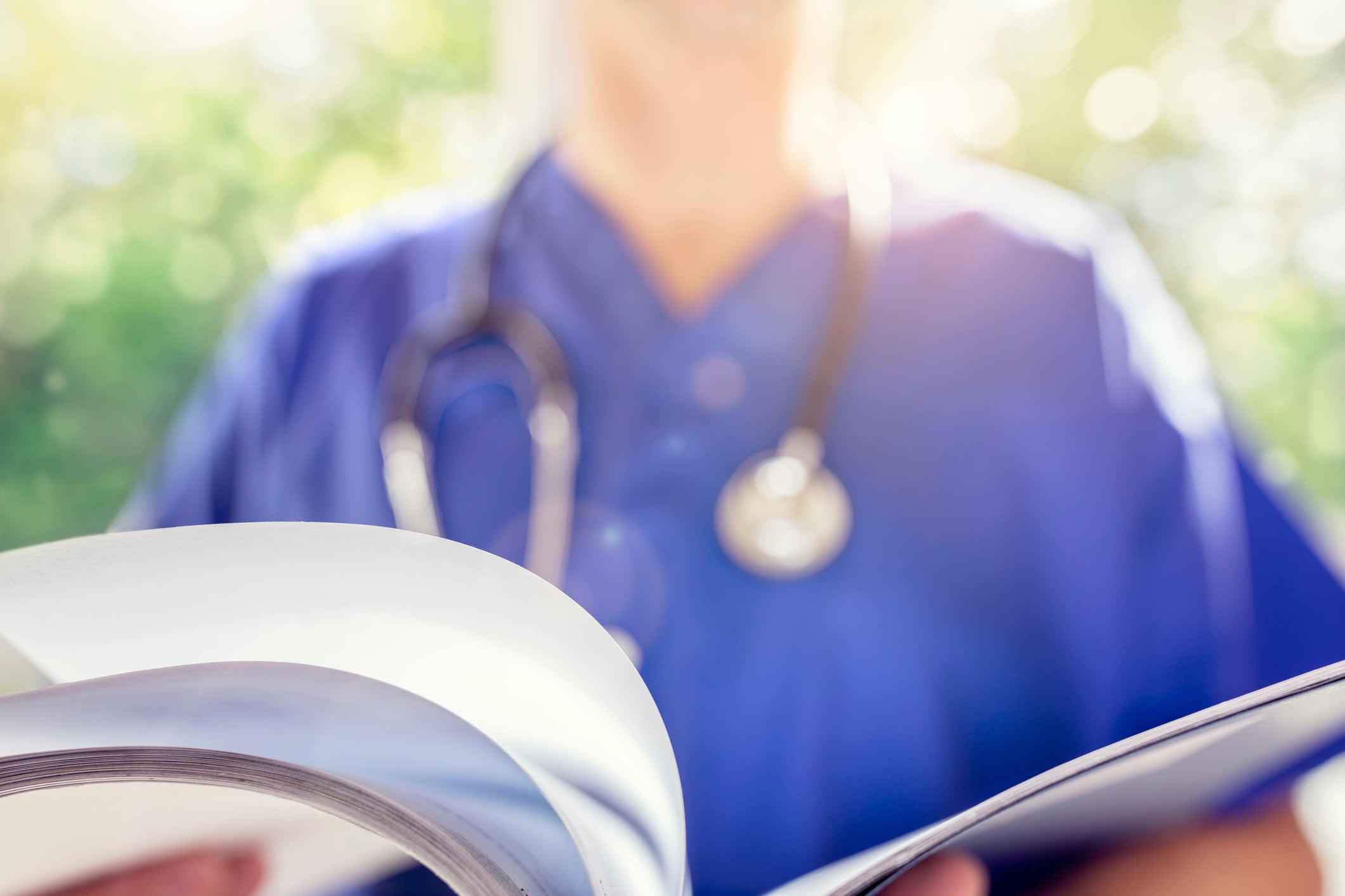 Medical practitioner reading a report