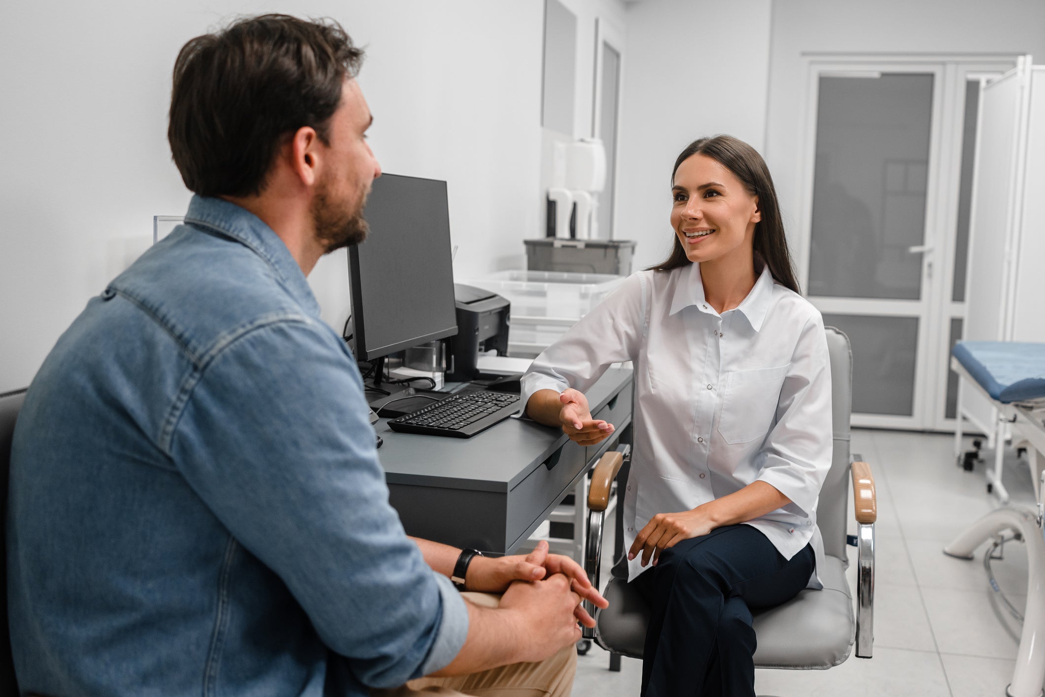 female doctor with patient and computor