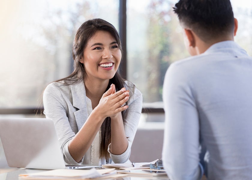 woman smiling and talking to a man