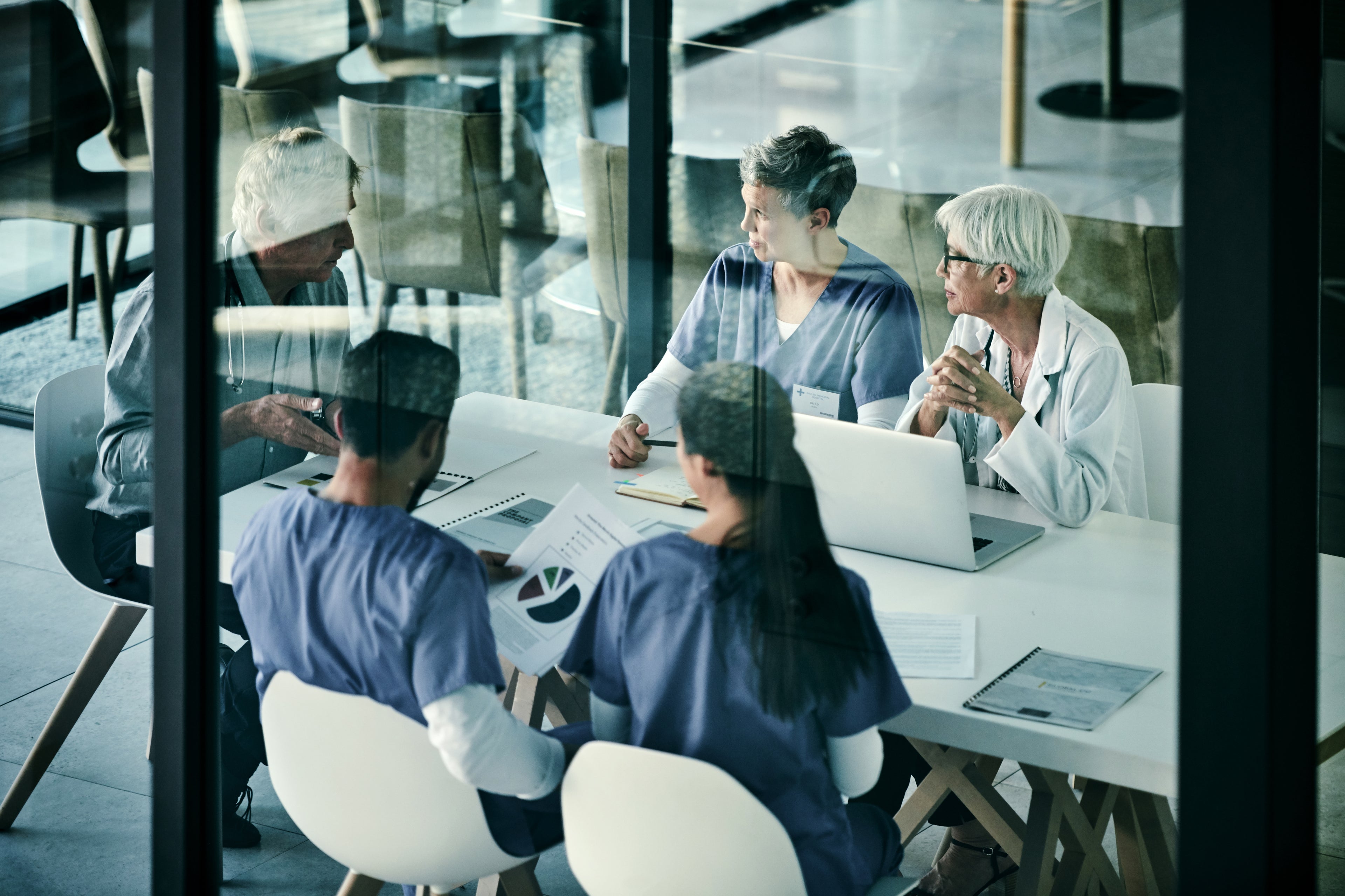 Doctors sitting around a table in a meeting