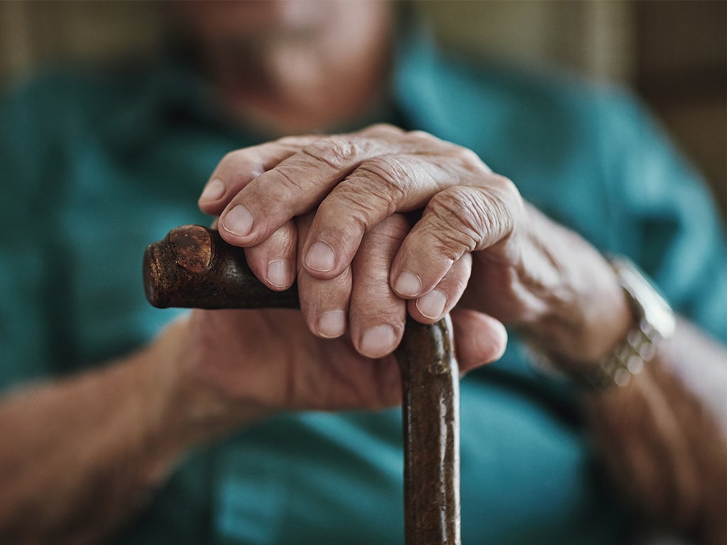 Elderly ladies hands holding walking stick