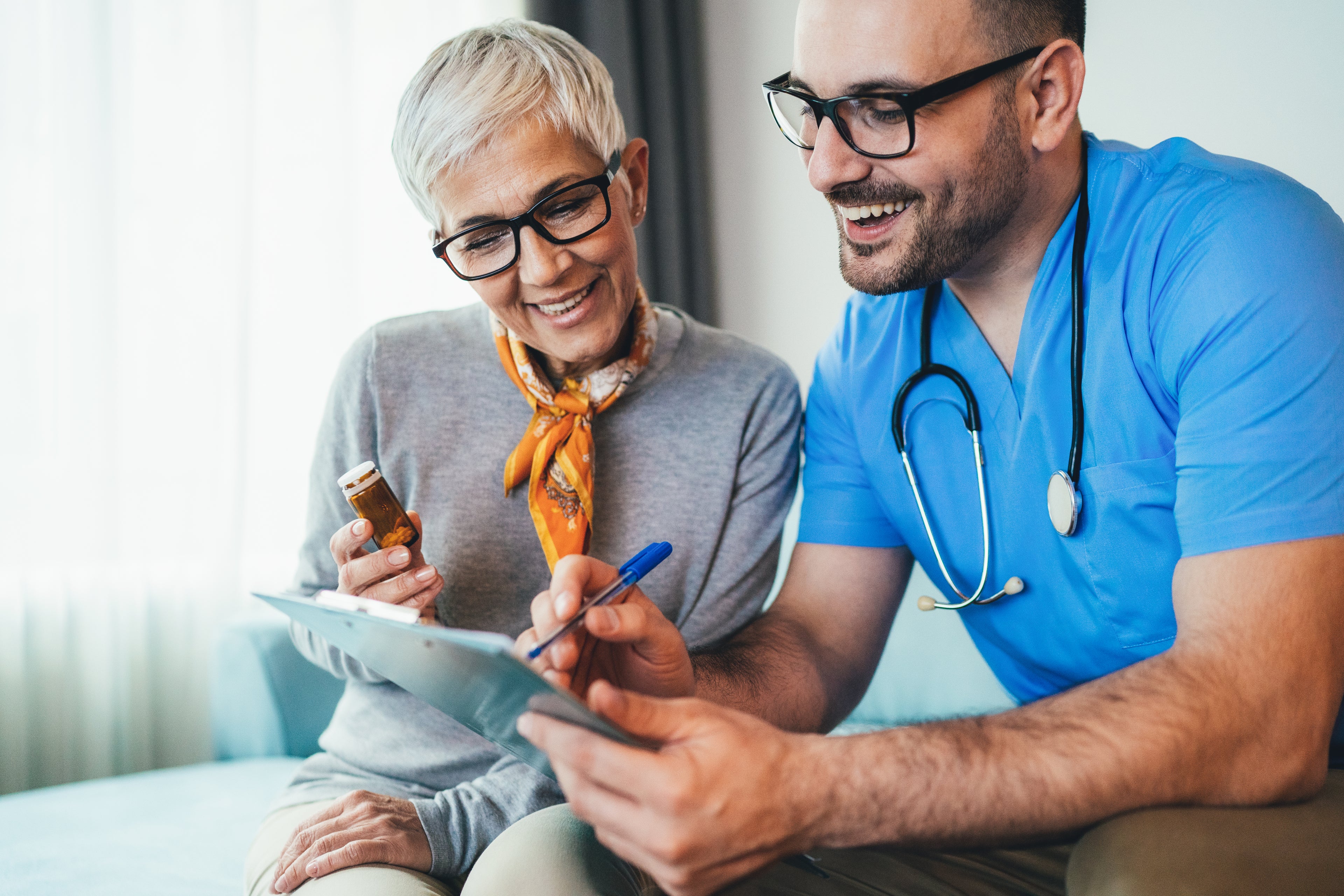 doctor smiling and show patient results on tablet