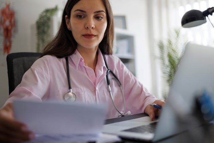 Image of female doctor staring at computer screen