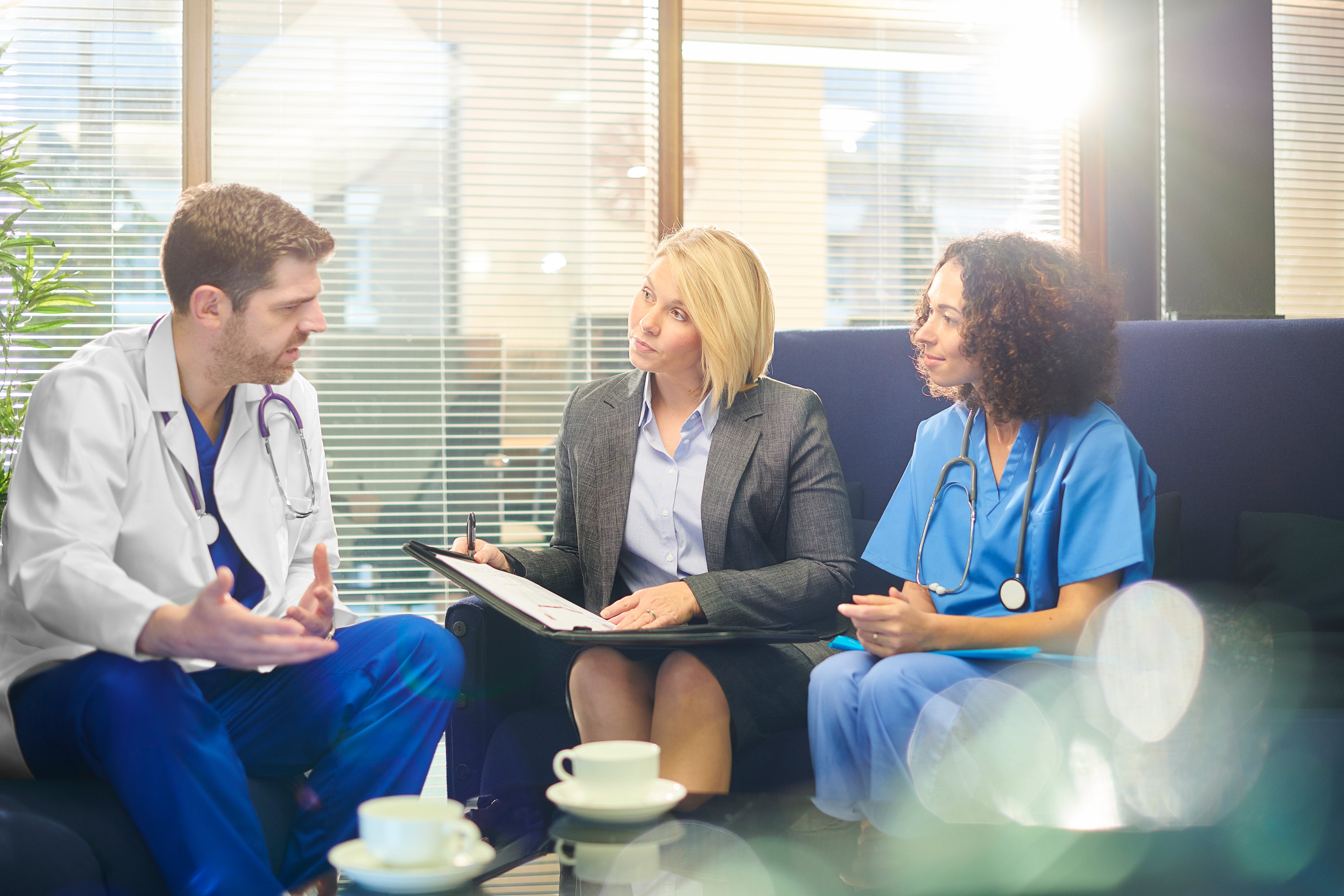 Doctor talking to patient and nurse