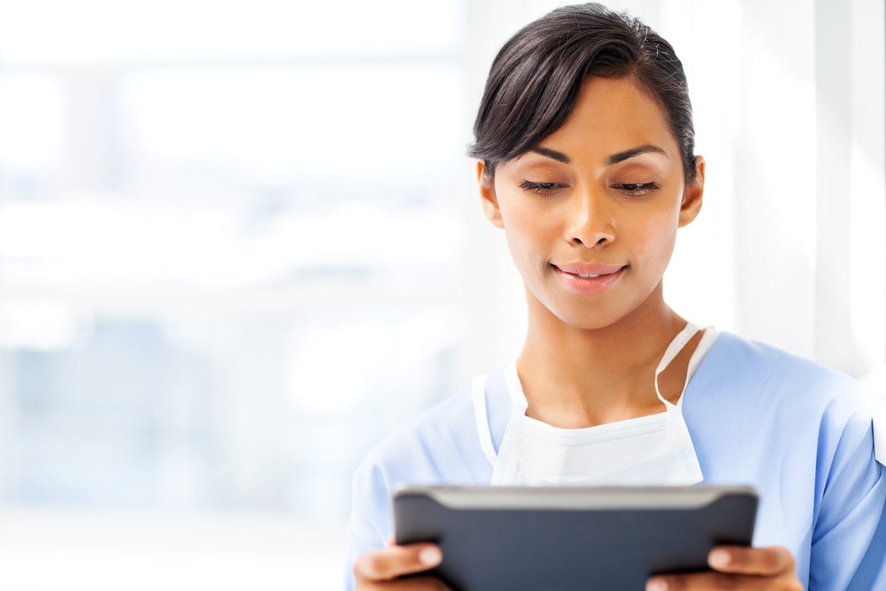 young female doctor looking at computer 