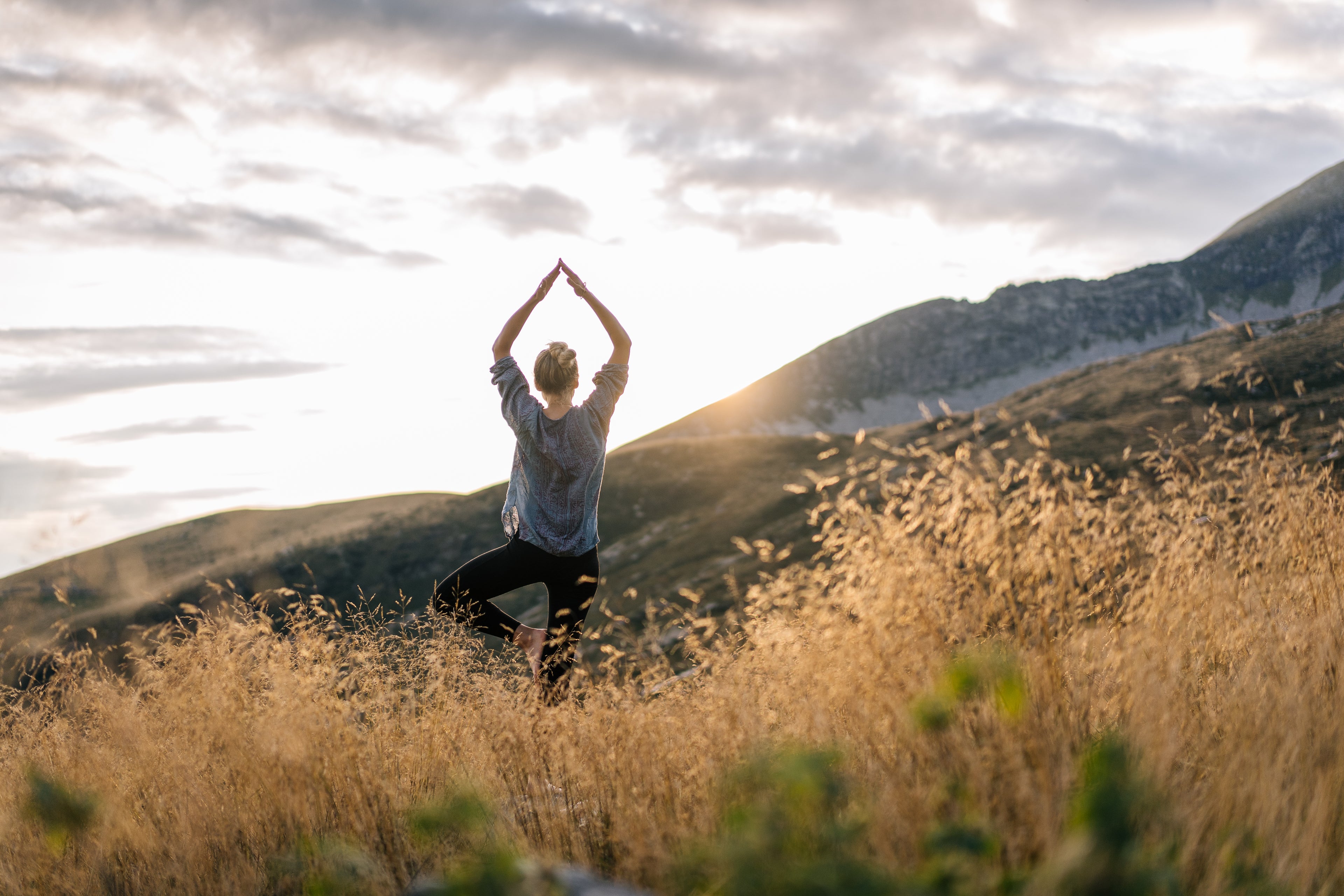 Person in field meditating