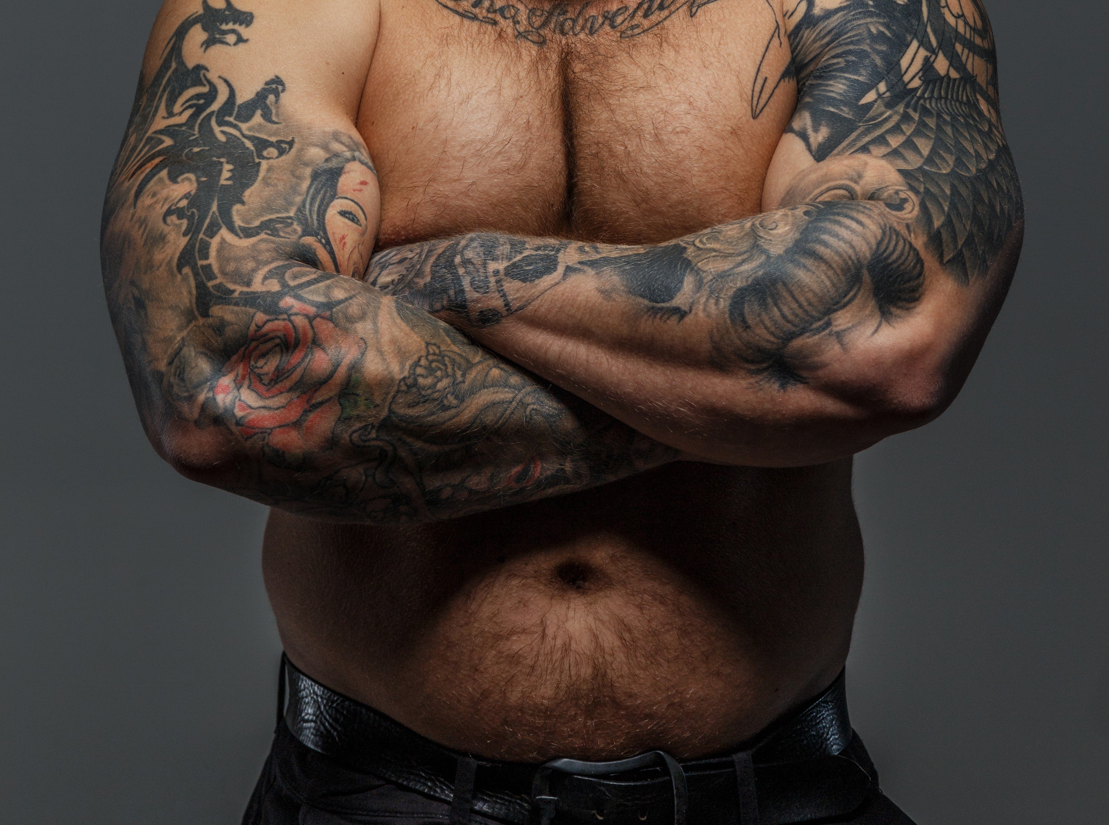 Biker with tattooed crossed arms
