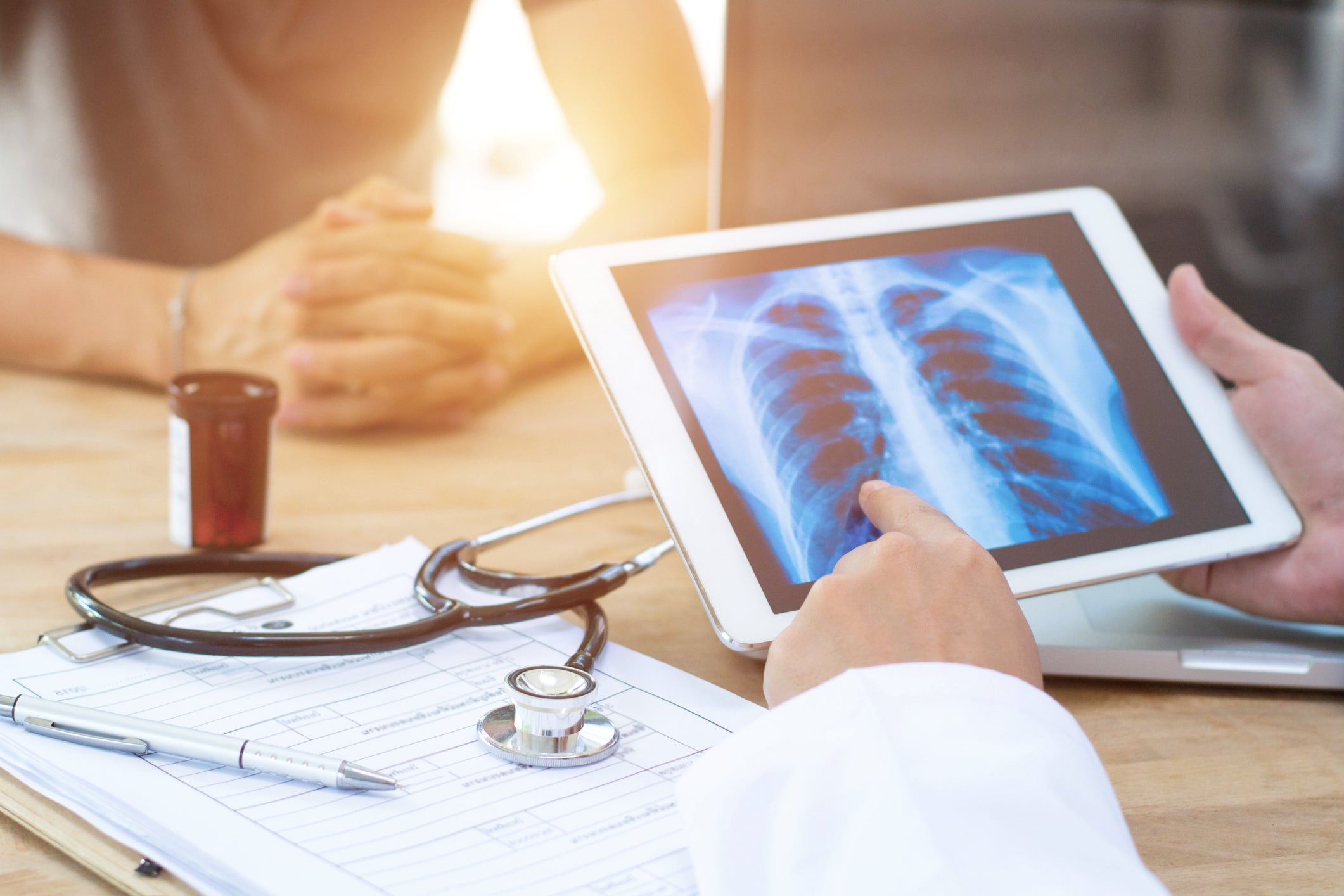 
Doctor holding iPad with chest x-ray on the screen