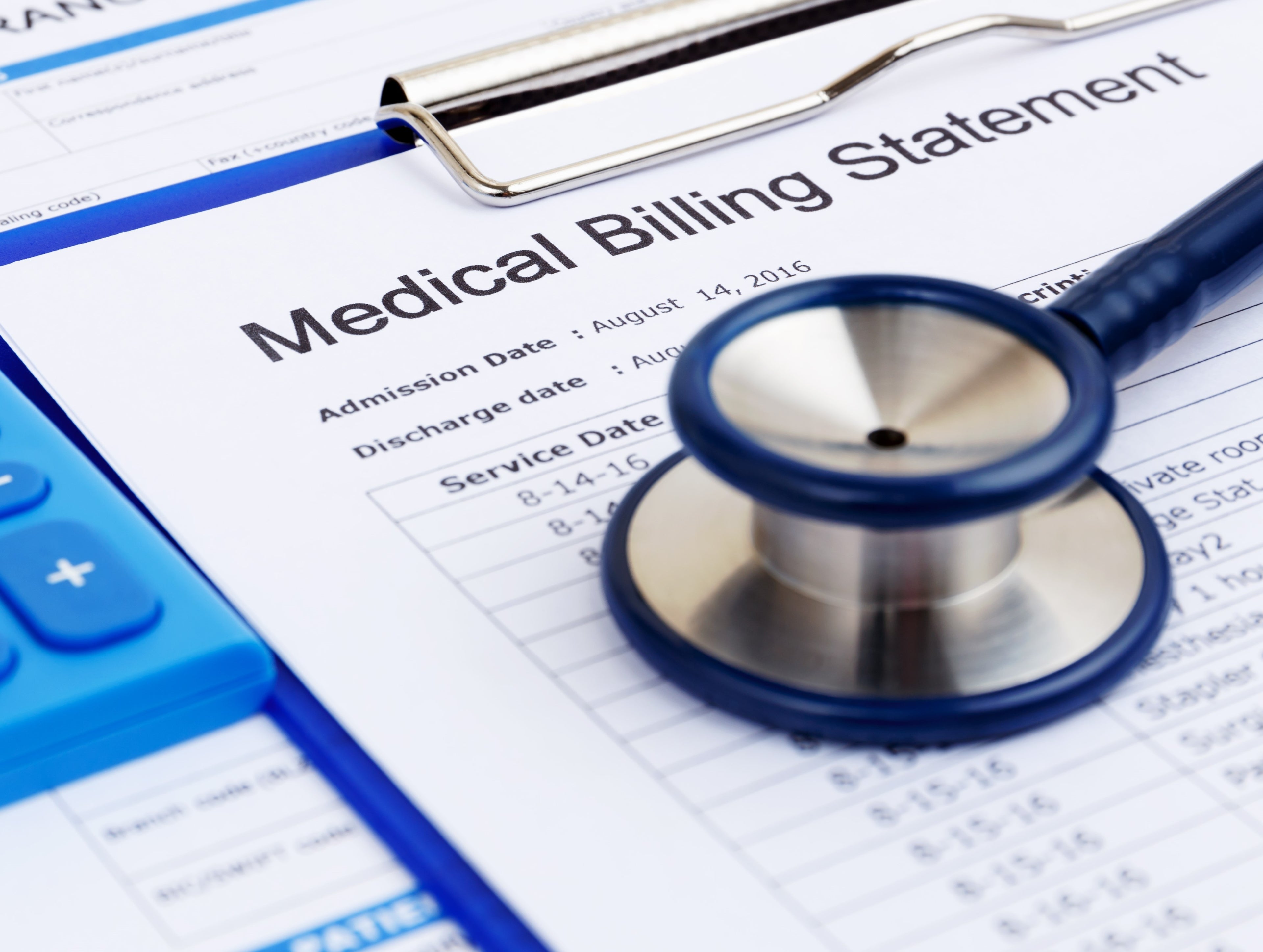 Stethoscope on top of medical billing statement