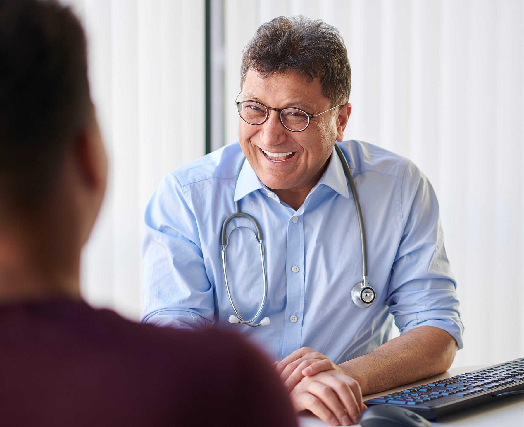 doctor smiling and talking with patient