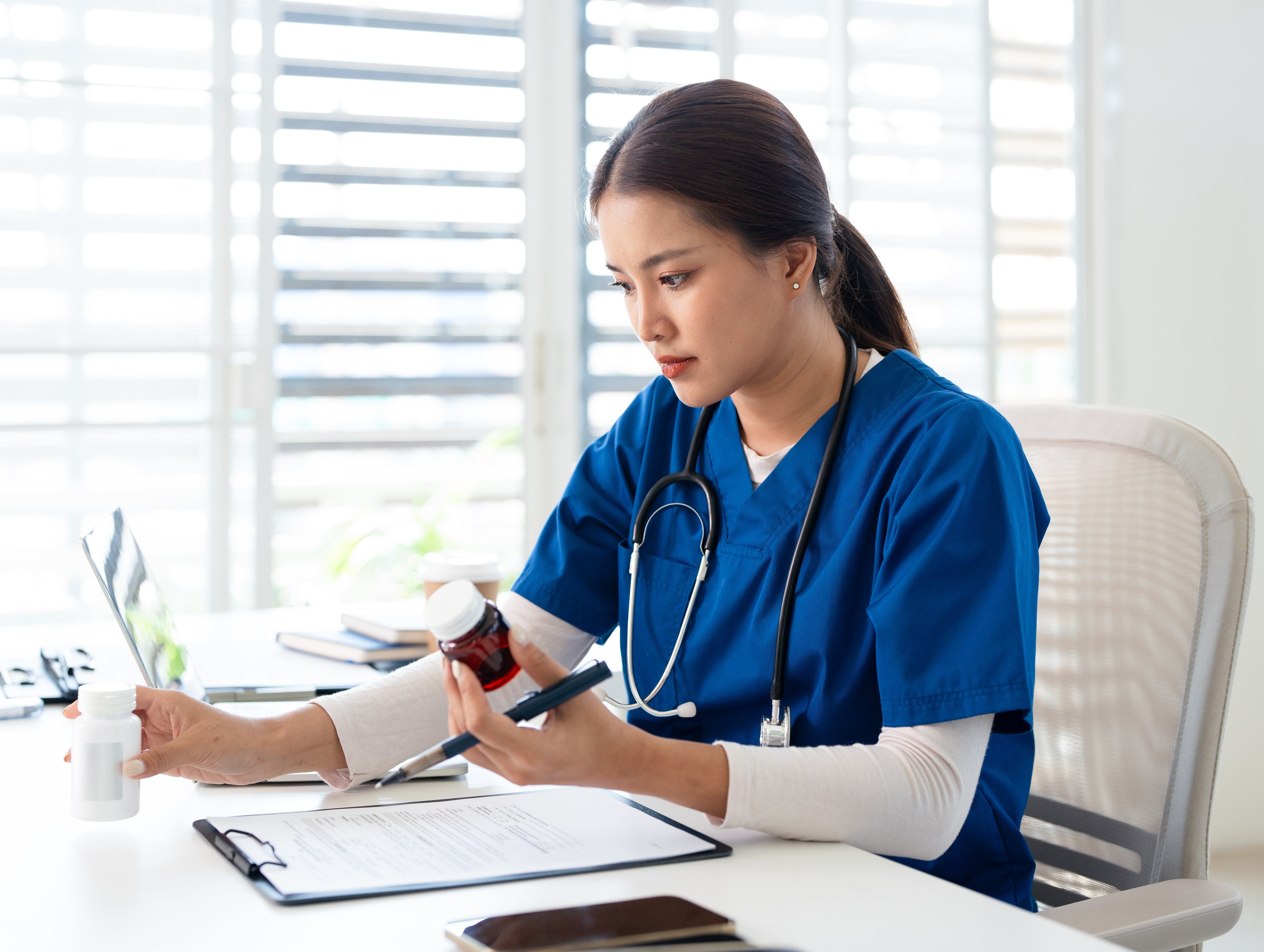 User on computer with stethoscope on desk