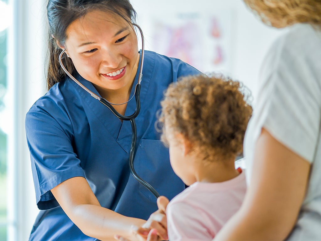 Female doctor with stethoscope and young child 