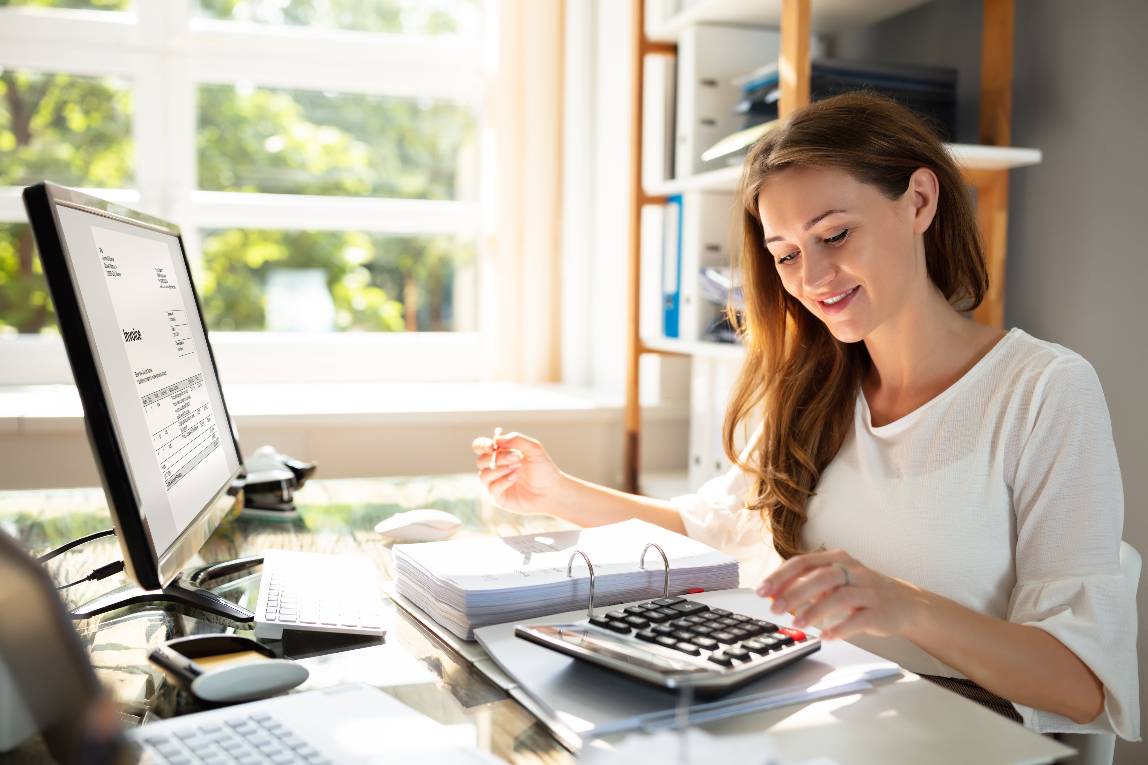 lady using computer and calculator