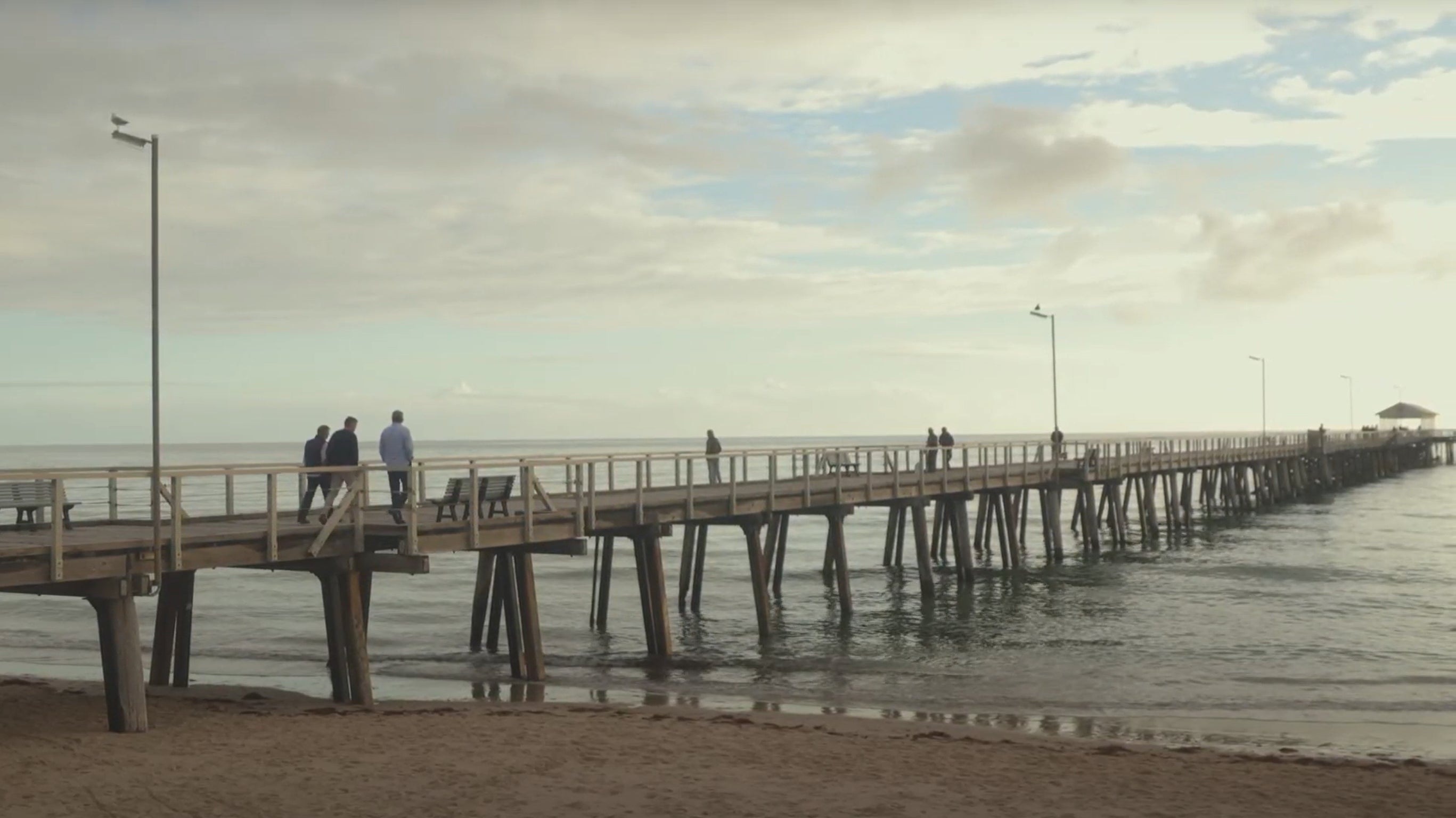 Dr Tony Alvino, Dr Aris Gatoudis and Jeremy Stagg walking on a boardwalk in Adelaide. 