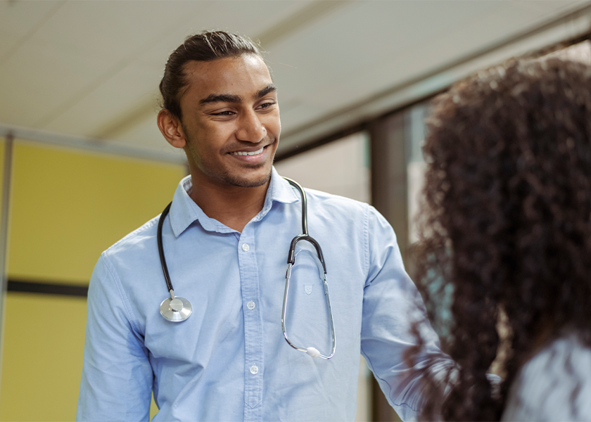 male doctor smiling at female patient