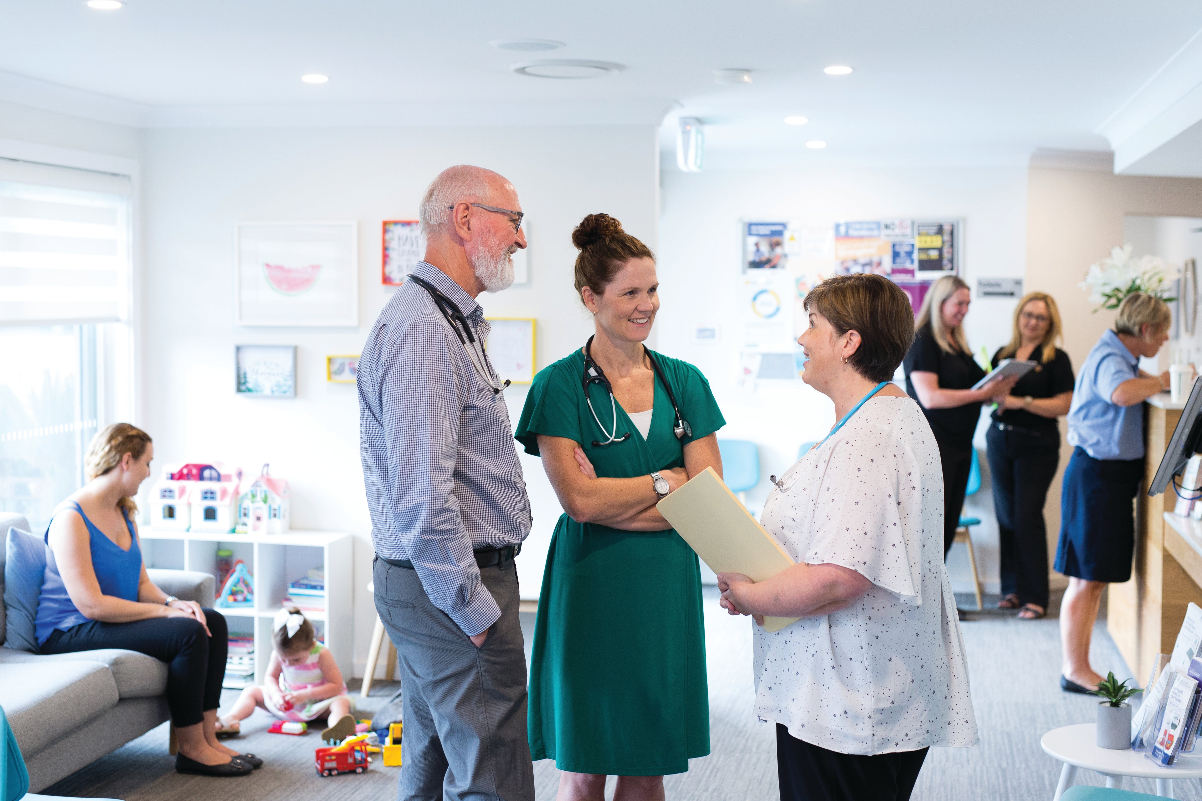 A doctor speaking to patients in a medical practice.