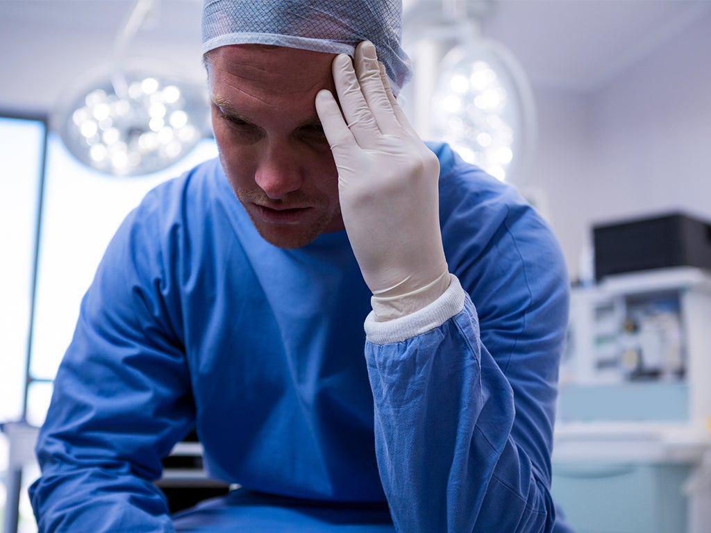 Male surgeon looking stressed