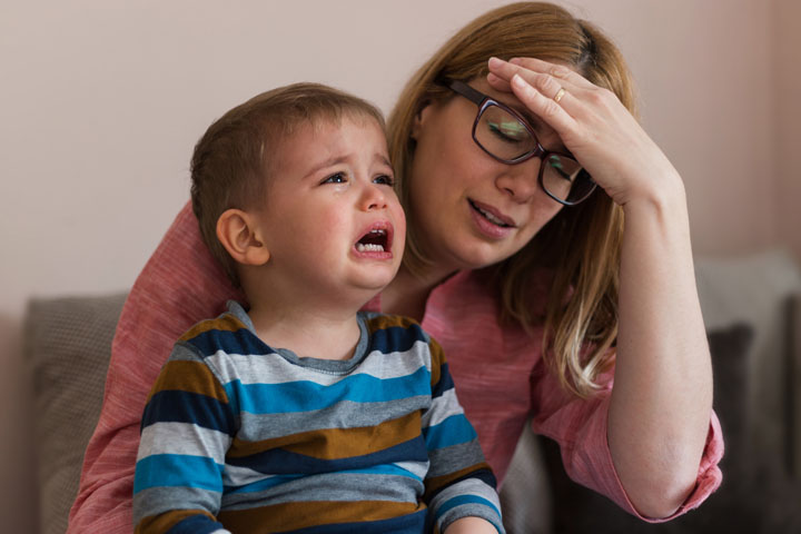 Woman in distress with crying baby