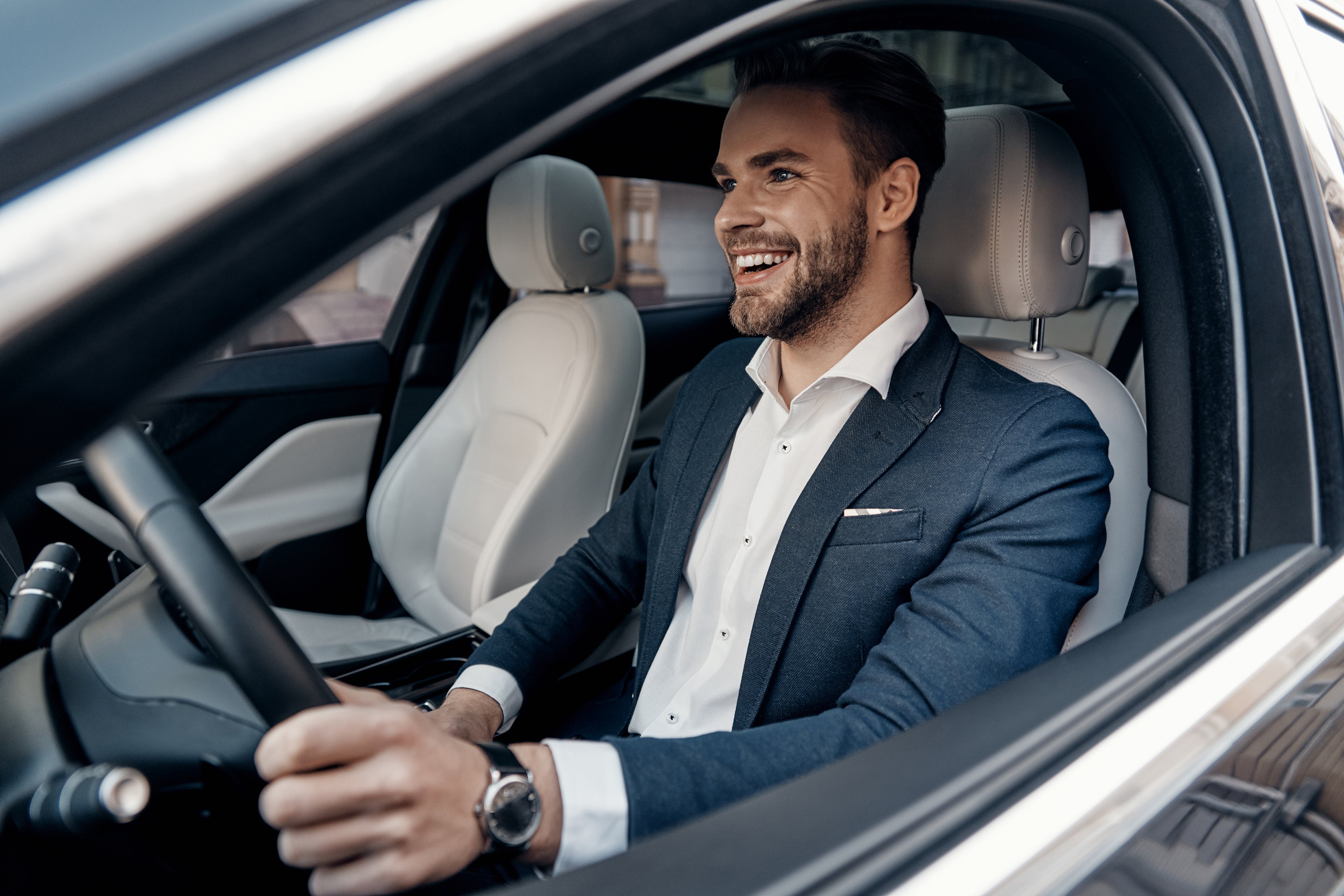 A man driving a car, representing car loans for dentists.