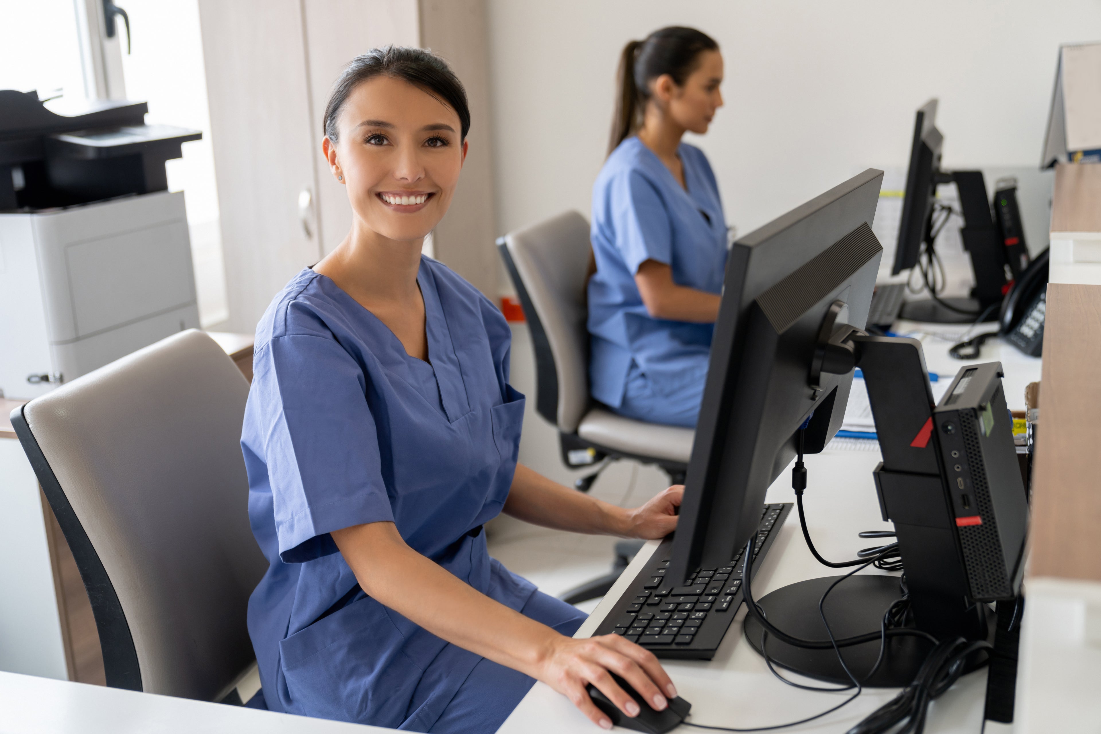 Nurse smiling at camera while working