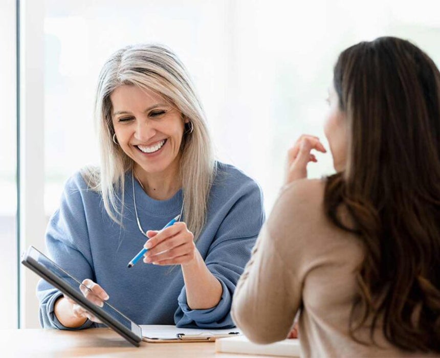 doctor talking patient while using tablet