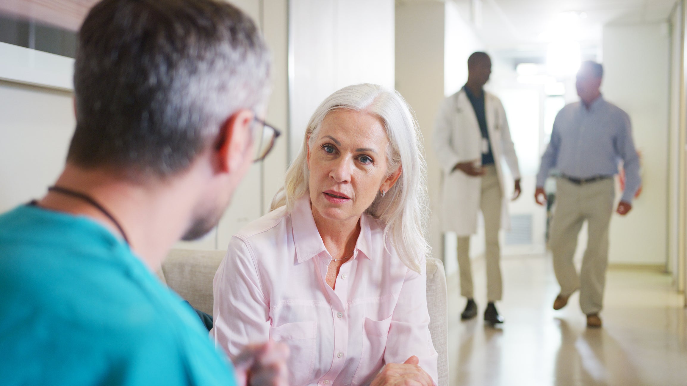 Surgeon speaking with a patient