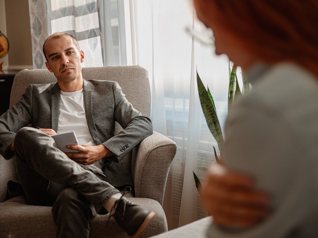 Psychiatrist sitting on couch talking to female patient