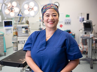 Doctor smiling standing in operating theatre