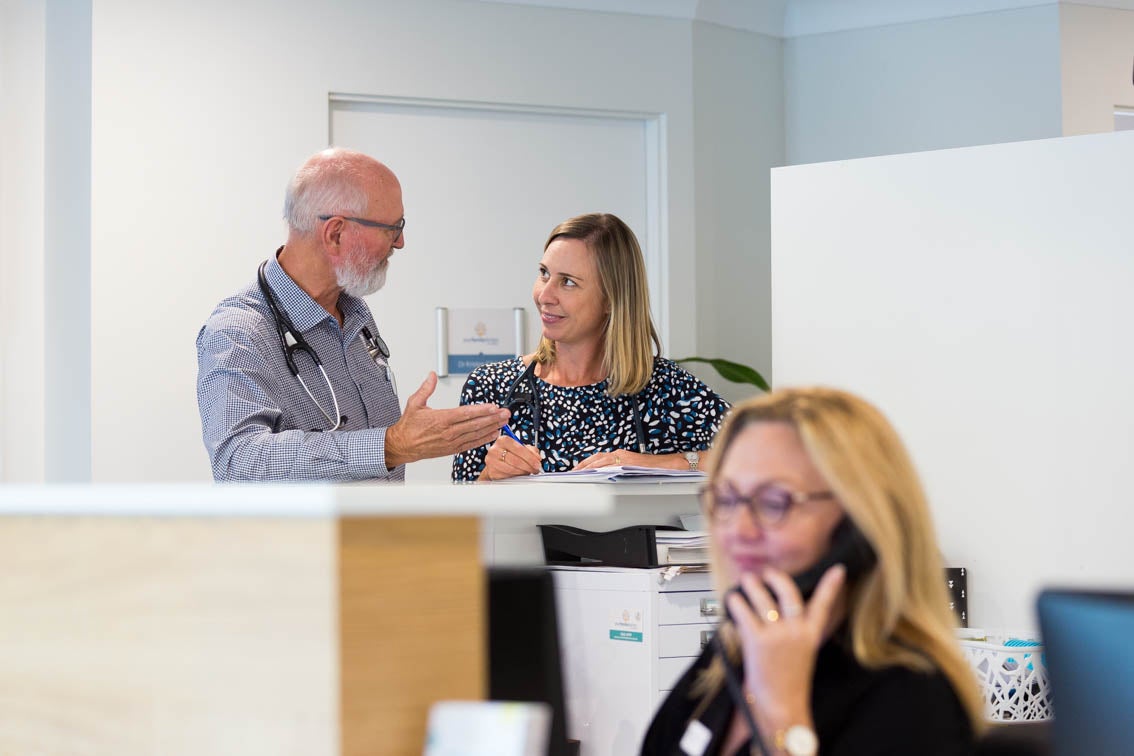 Doctors talking in medical centre reception