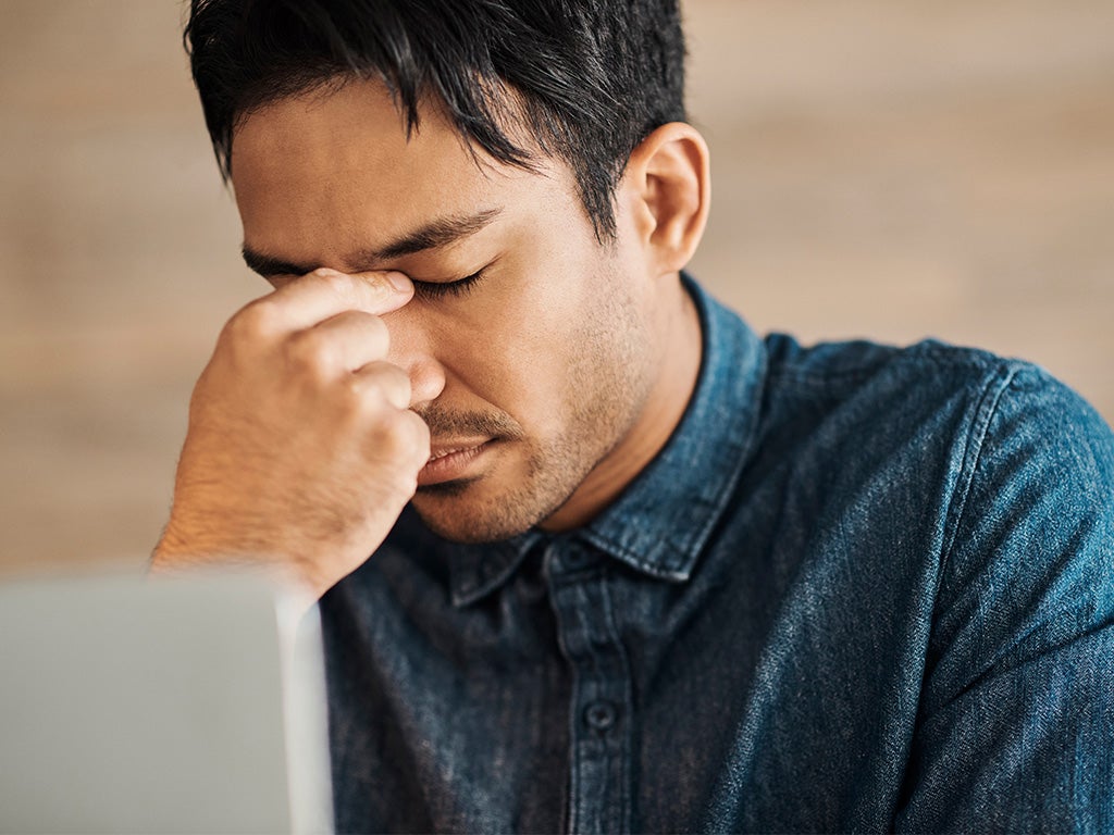 Male pinching the bridge of his nose