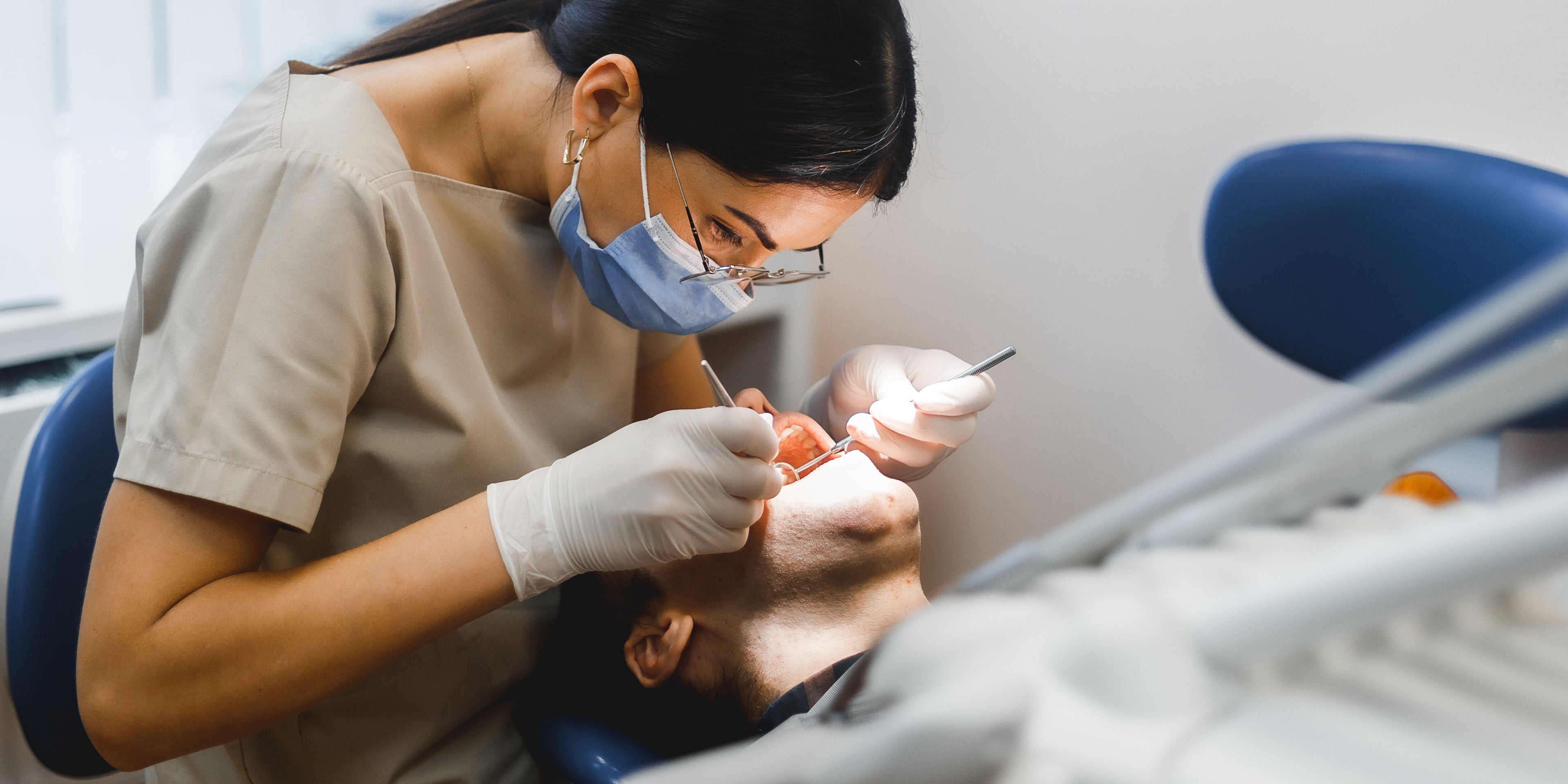 A dental professional in his workplace evaluating options for dental practice loans.