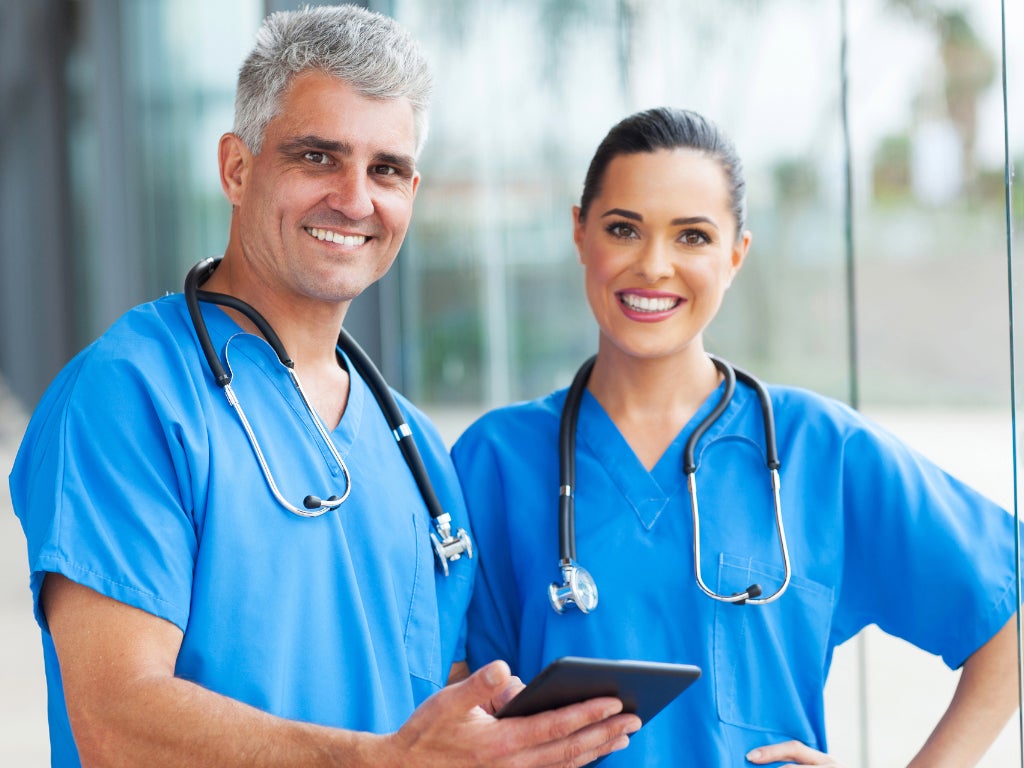 Two doctors standing in scrubs with stethoscope around their necks