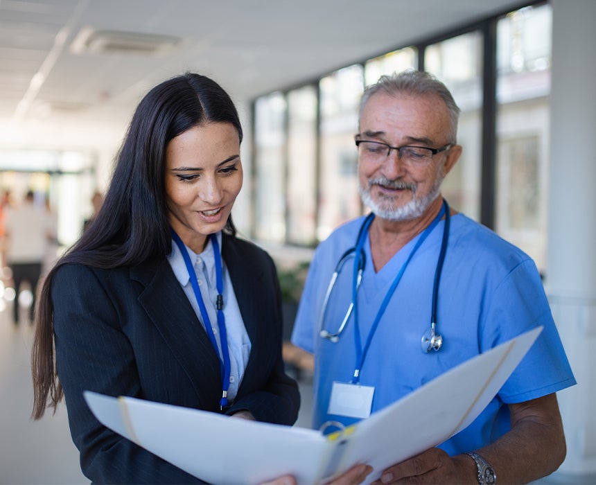 Two doctors talking and reviewing a file