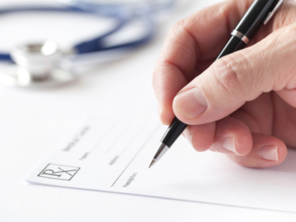 User holding a pen and writing on paper