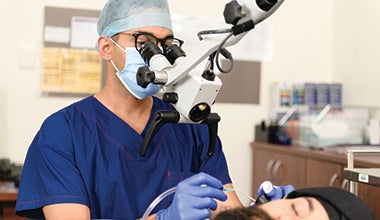 A male doctor performing an operation 