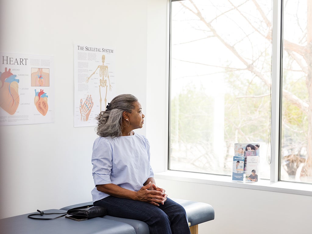 Lady sitting and waiting on medical table