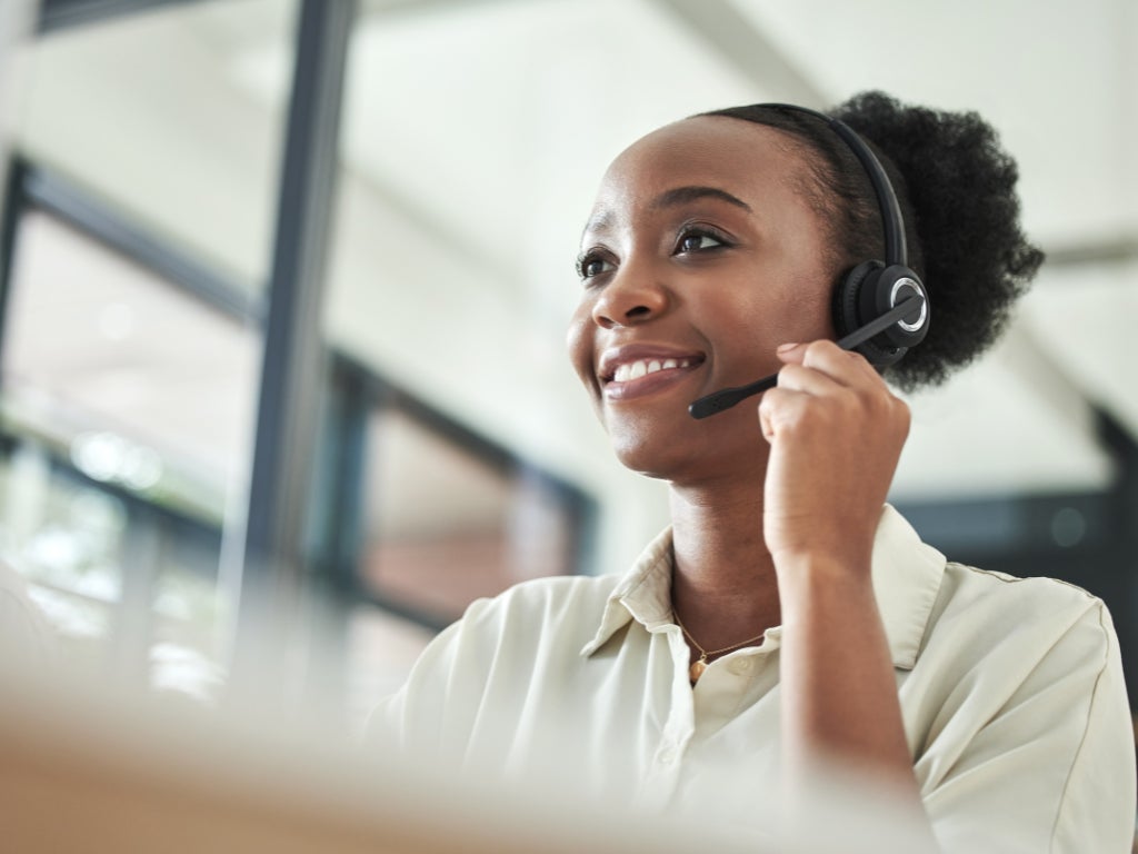 Lady at reception desk on phone 