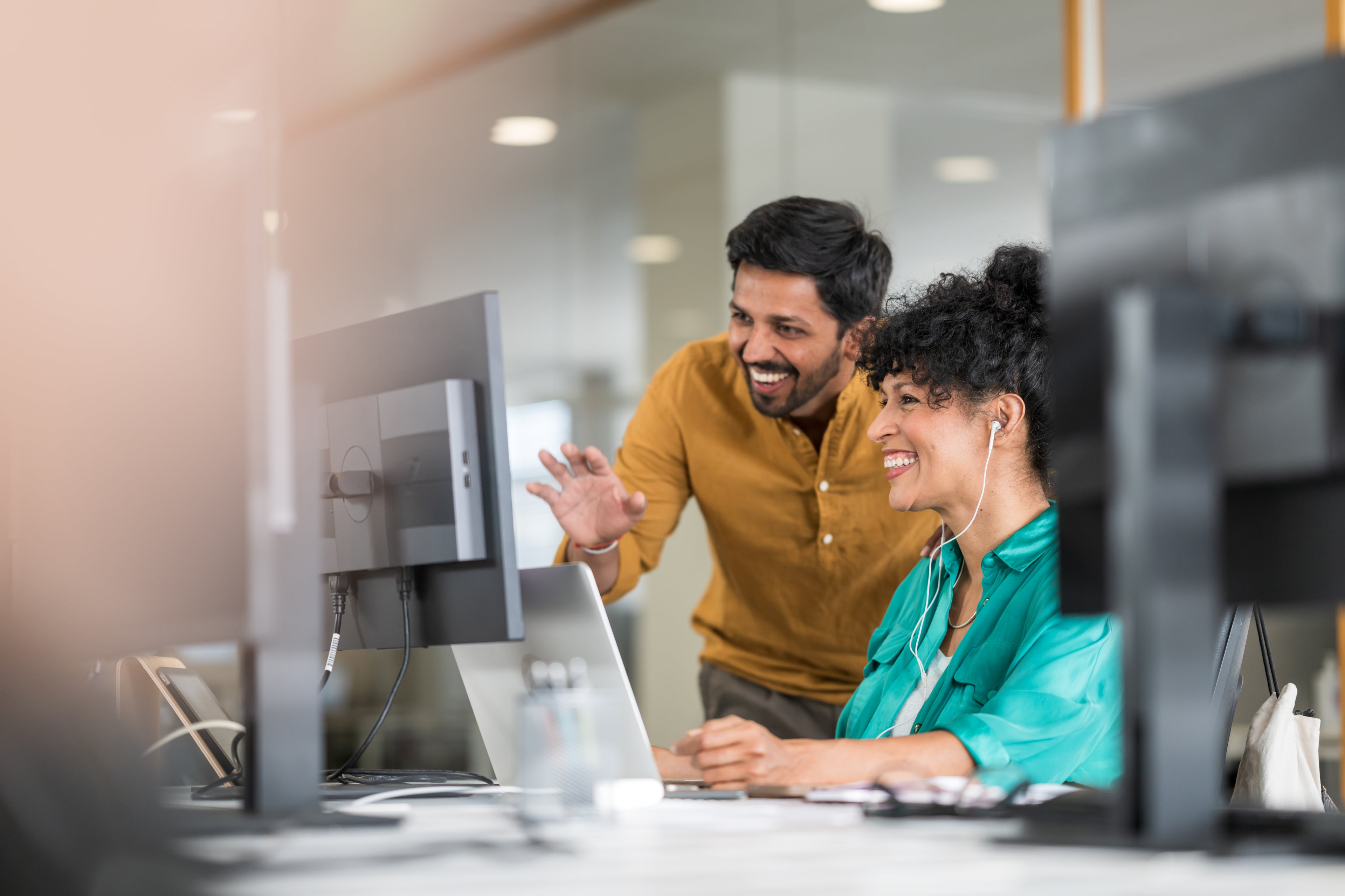 Peers working and smiling at their computer