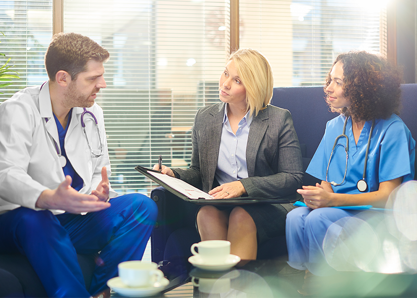 Doctor talking to patient and nurse