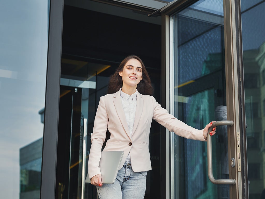 Female walking out of building doors