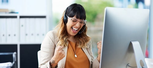 person celebrating at their computer