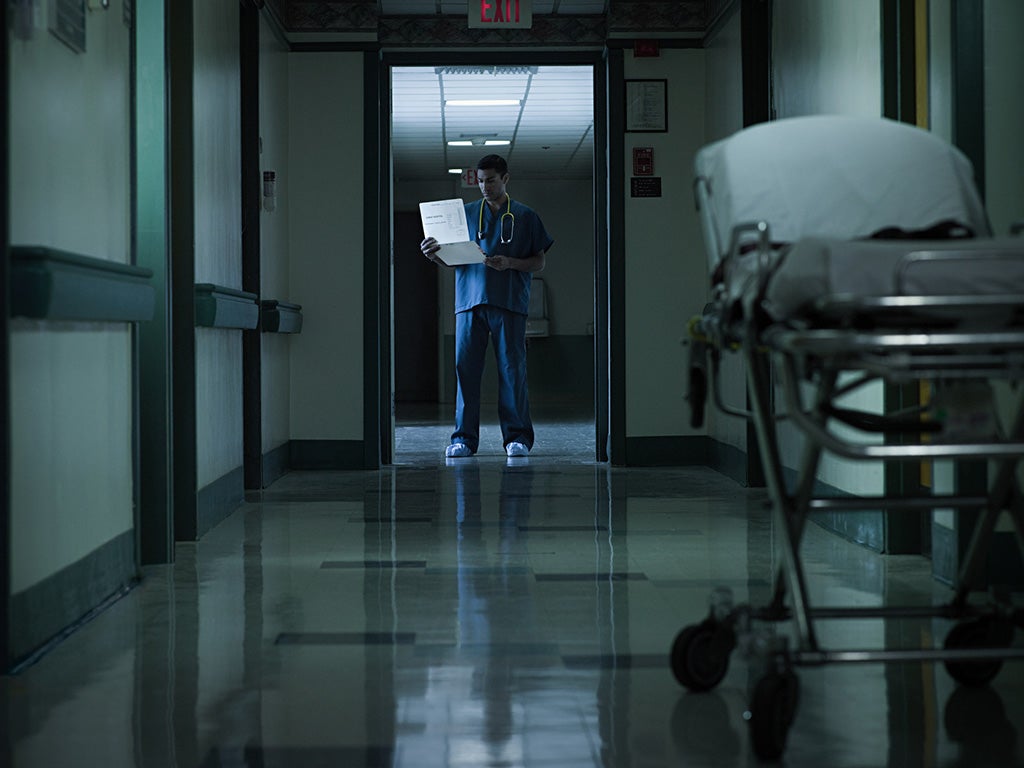 Doctor in hospital corridor at night time