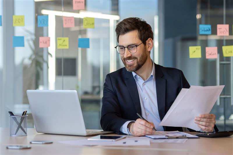 man smiling at laptop