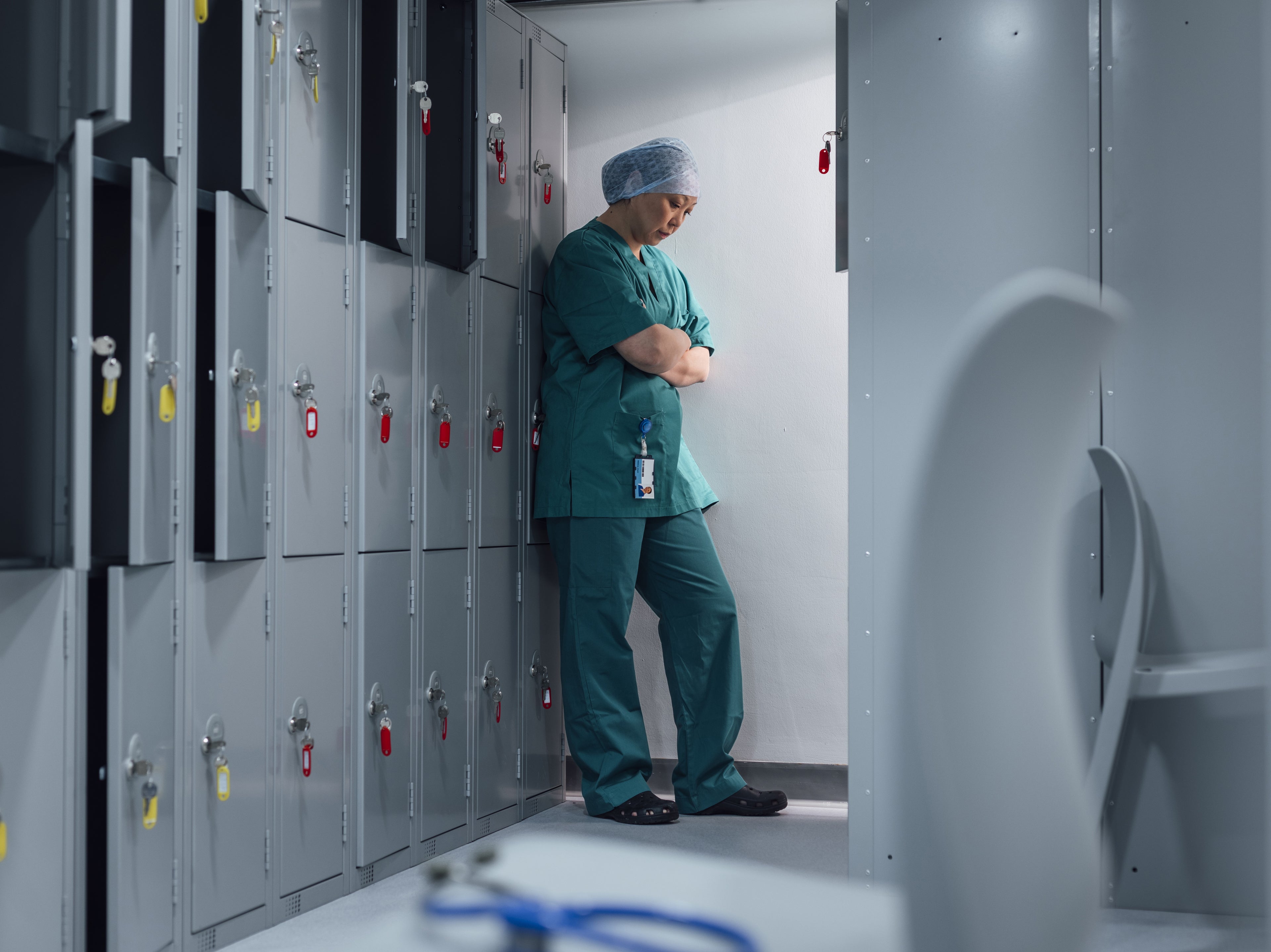 doctor in scrubs upset in locker room