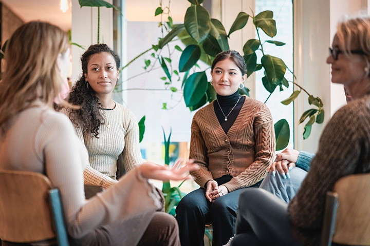 Group of women sitting down conversing