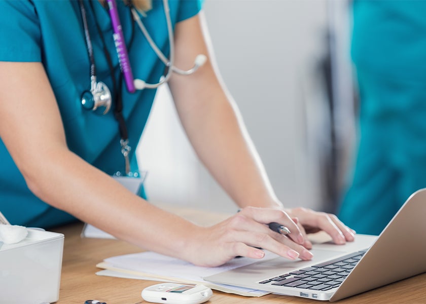 doctor typing on computer