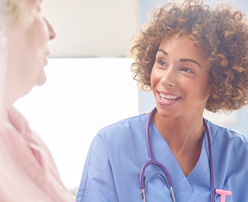 nurse smiling and talking with patient