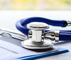 Stethoscope lying next to medical instruments on a table