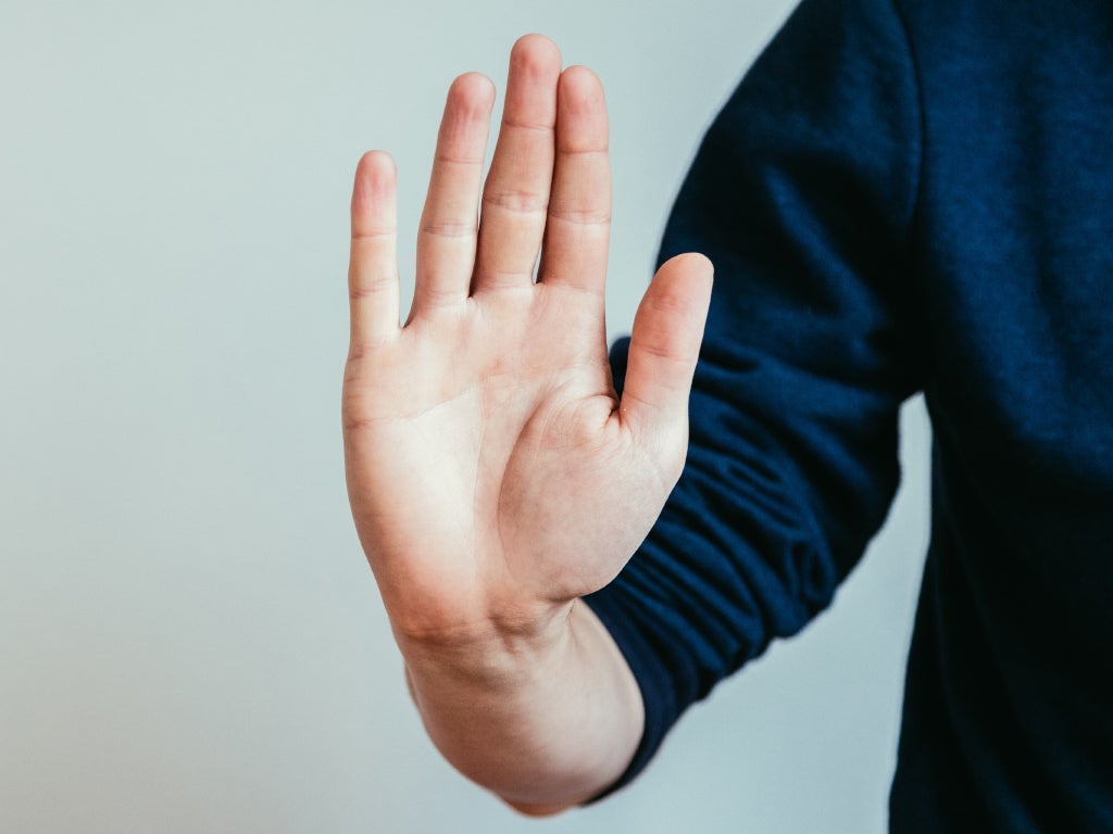 person holding hand up in a stop gesture